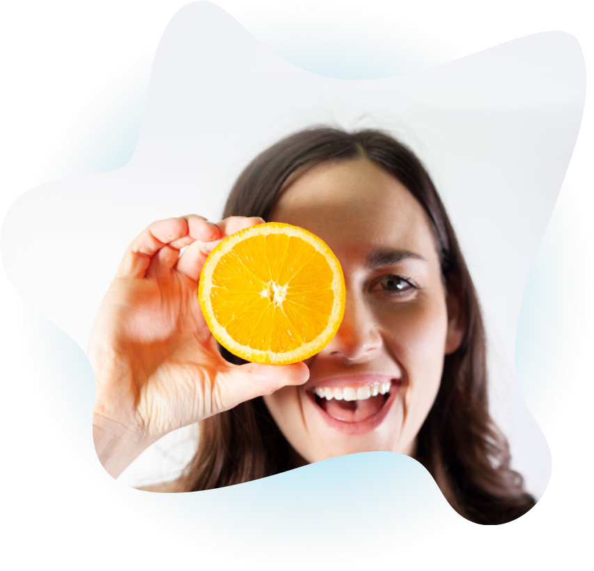 Woman smiling holding an orange