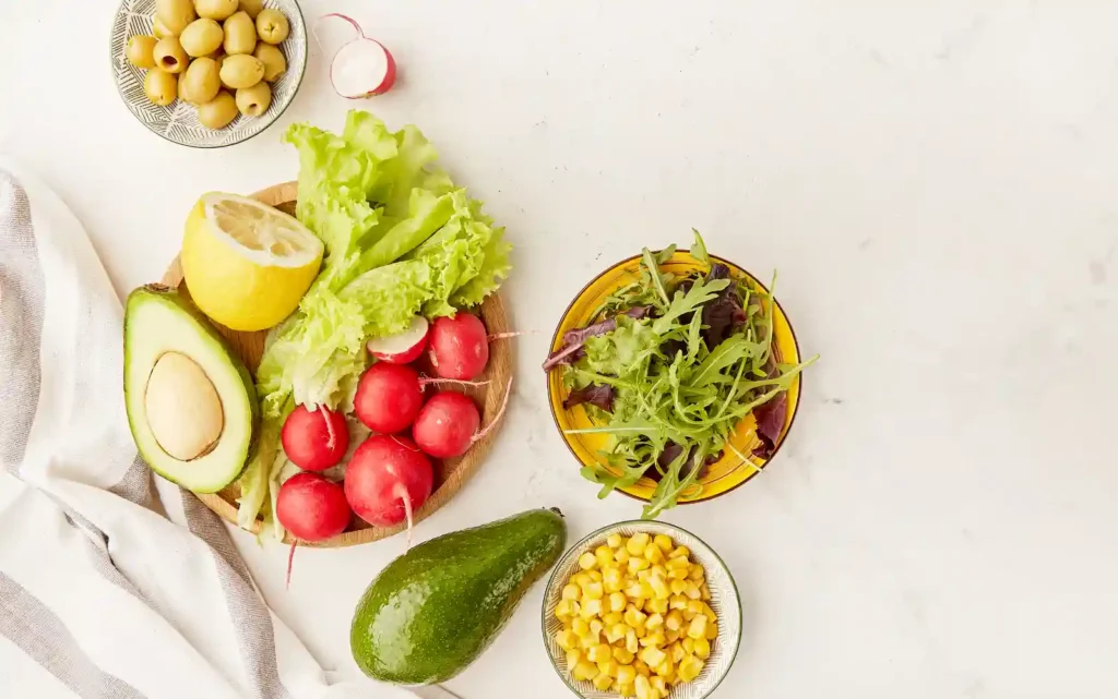 Eggplant, salad, radishes, and other vegtables in bowls