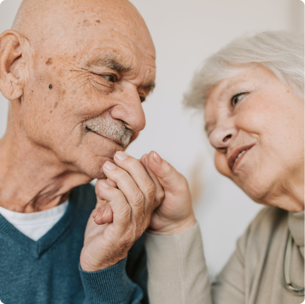 Elderly couple holding hands