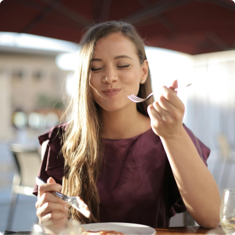 Woman smiling while eating