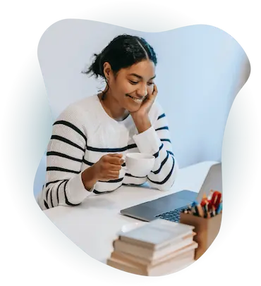 Woman drinking coffee on laptop
