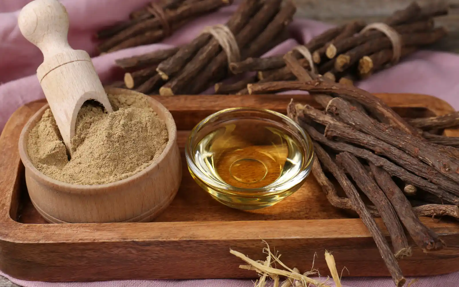 Dried Licorice root on a wooden tray.