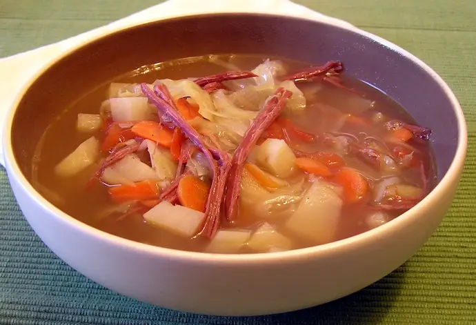 Corned Beef and Cabbage soup in a white bowl