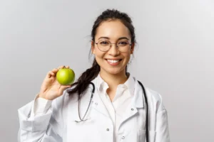 Portrait of a professional confident young asian dietitian in a white scrub