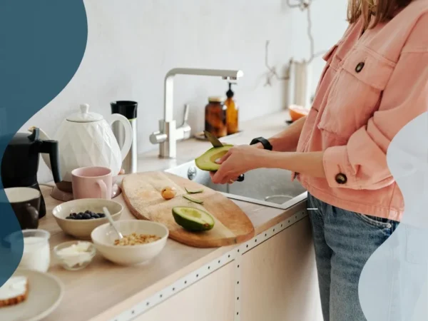 A woman in a pink jacket preparing a PCOS breakfast