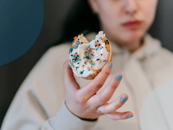 A woman feels guilty for eating a donut
