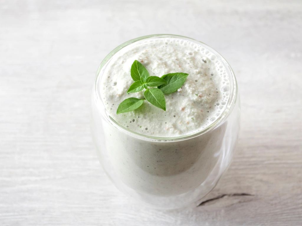Avocado yogurt lassi garnished with basil