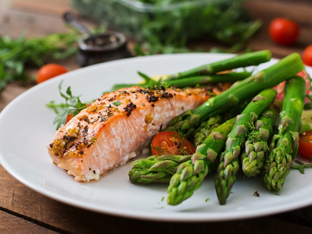 Baked salmon fillet served with tomatoes, roasted asparagus, and dill