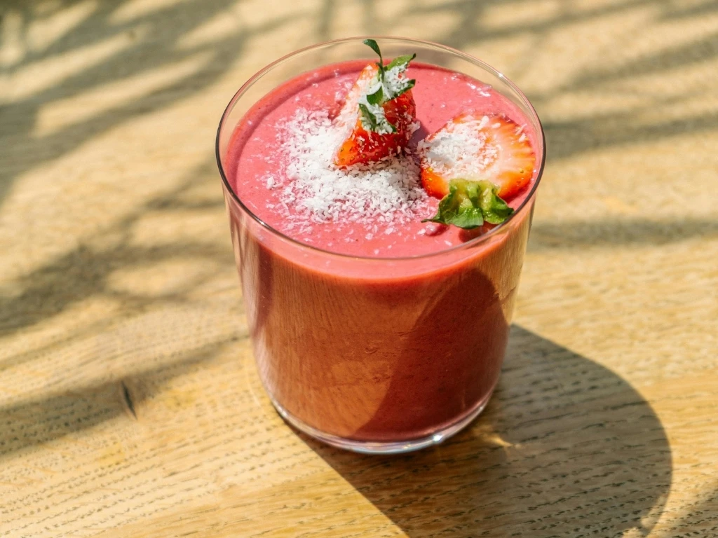 Clear Drinking Glass With Red Liquid on Brown Wooden Table