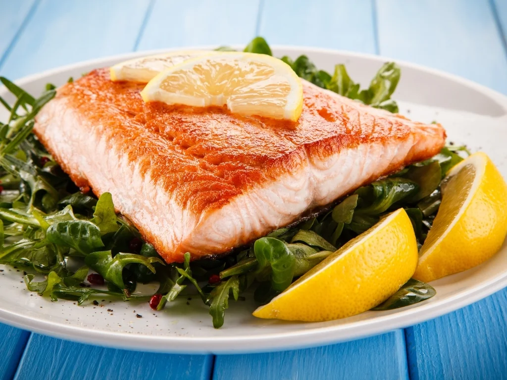 Lemon-herb grilled salmon over arugula