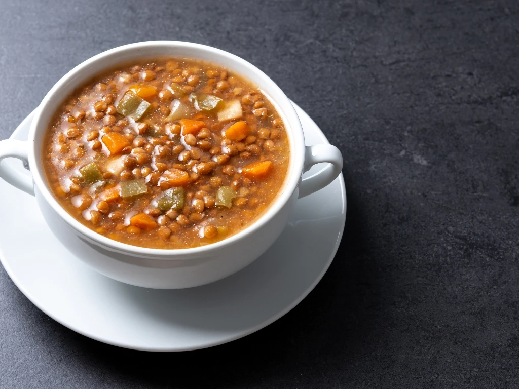 Bowl of lentil soup on a white saucer