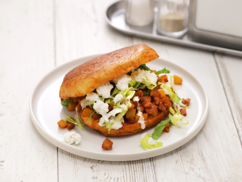 Lentil sloppy joe on a whole-grain bun, served on a white plate