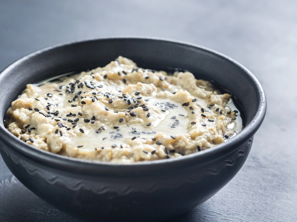 Bowl of ricotta served with black sesame seeds