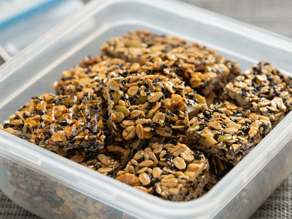 Seed granola bars in a transparent square container