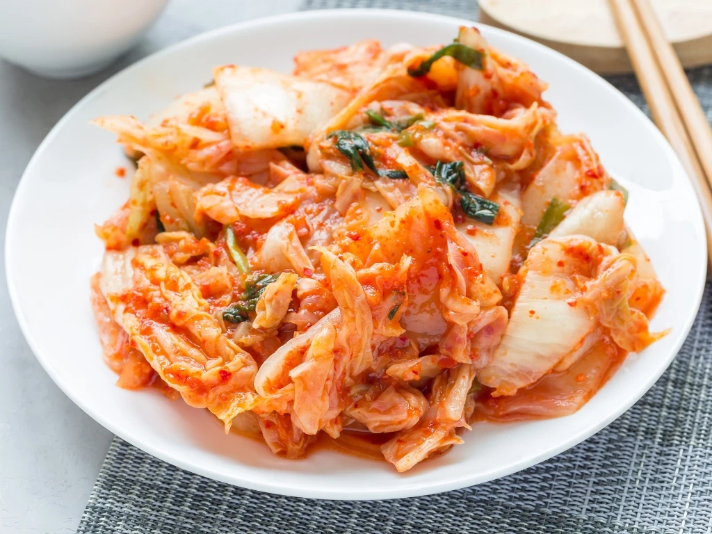 Plate of kimchi served with chopsticks