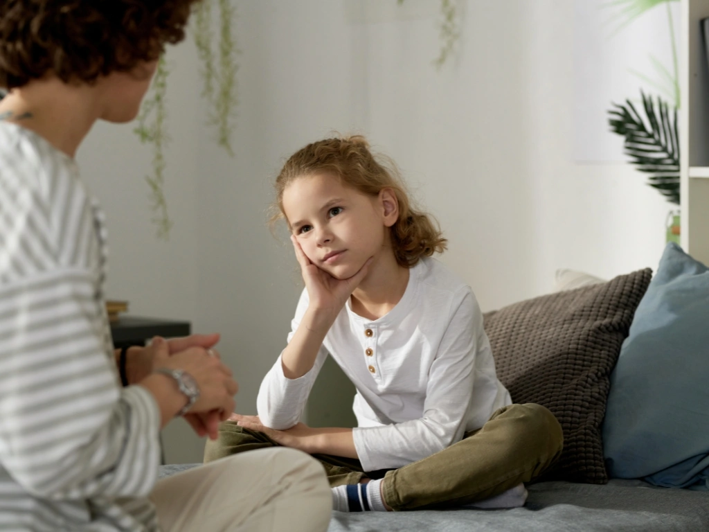 Little girl listening intently to a specialist