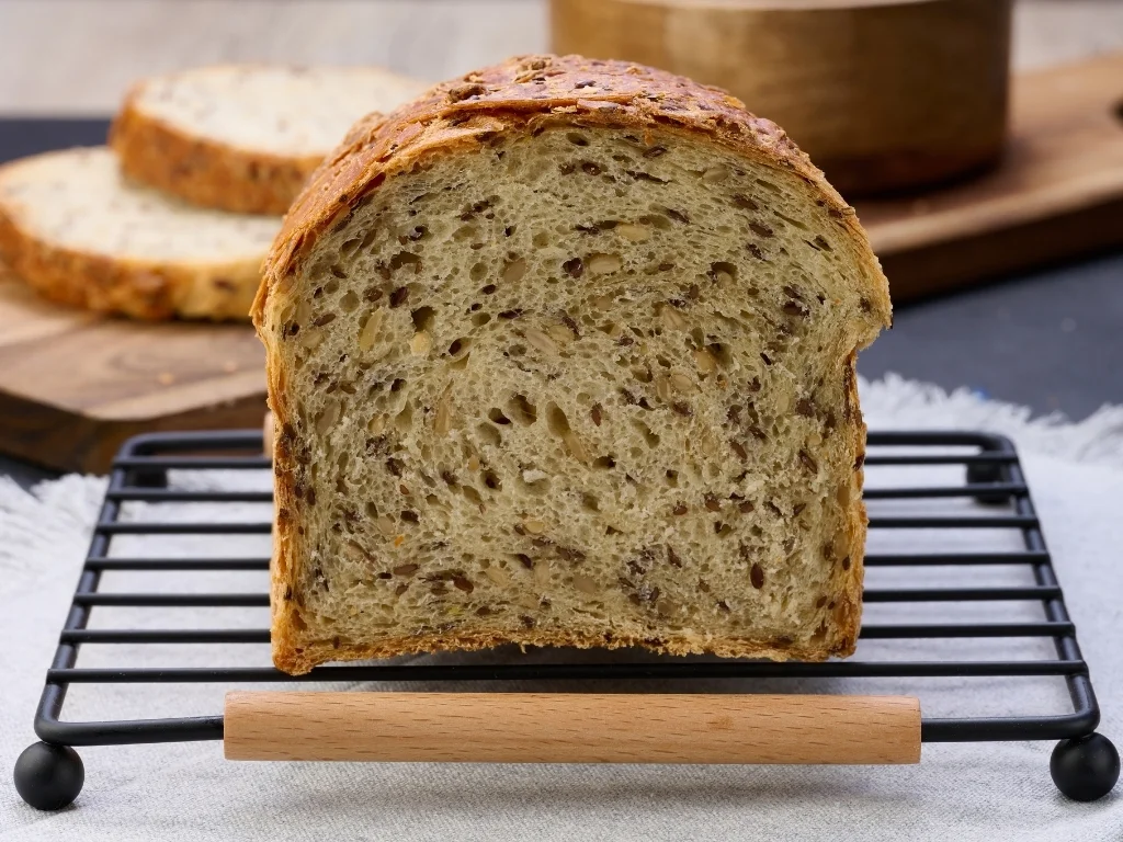 Sliced flaxseed bread loaf displayed on a tray