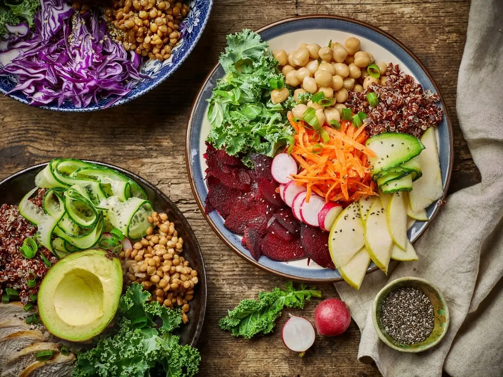 Breakfast power bowls for healthy eating on wooden kitchen table, top view.