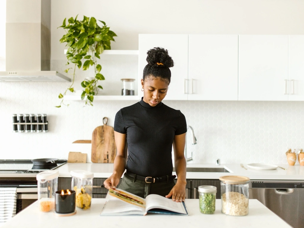 Woman reading up on recipes ahead of preparing SIBO-friendly meals