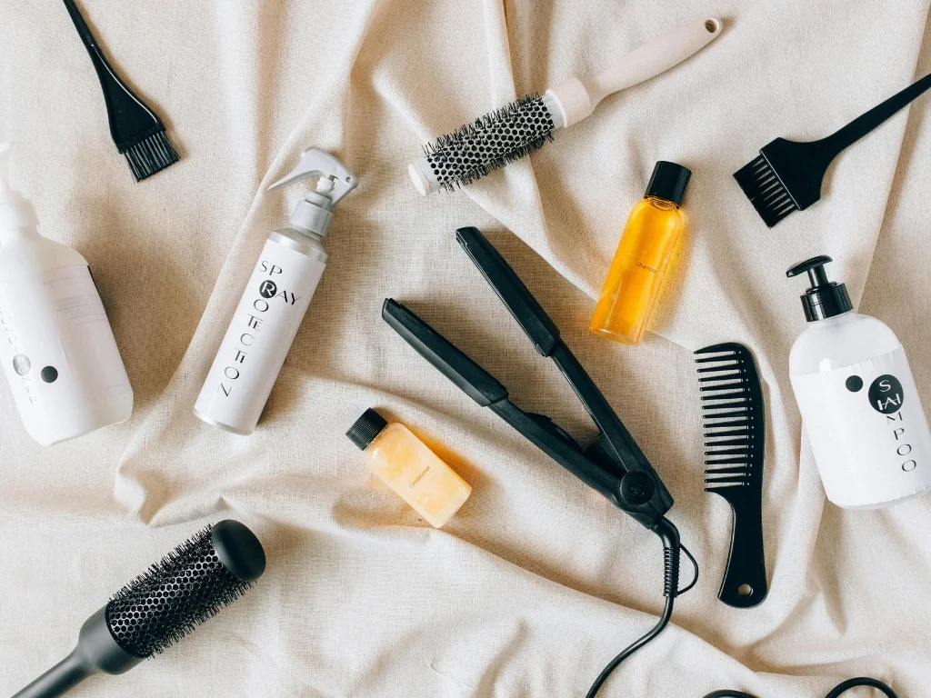  Assorted hair care and styling tools, including combs, brushes, and hair products