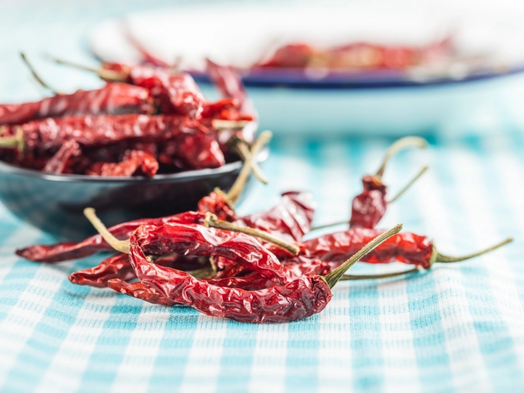 Red chili peppers on a blue and white tablecloth