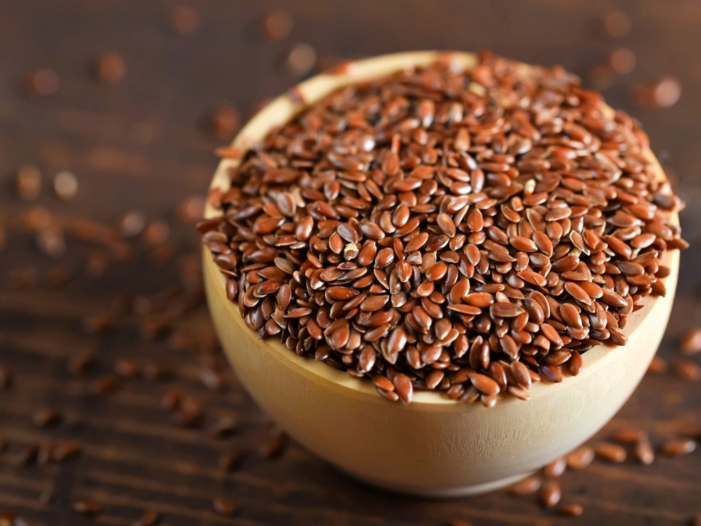 Bowl of flaxseeds on a wooden surface