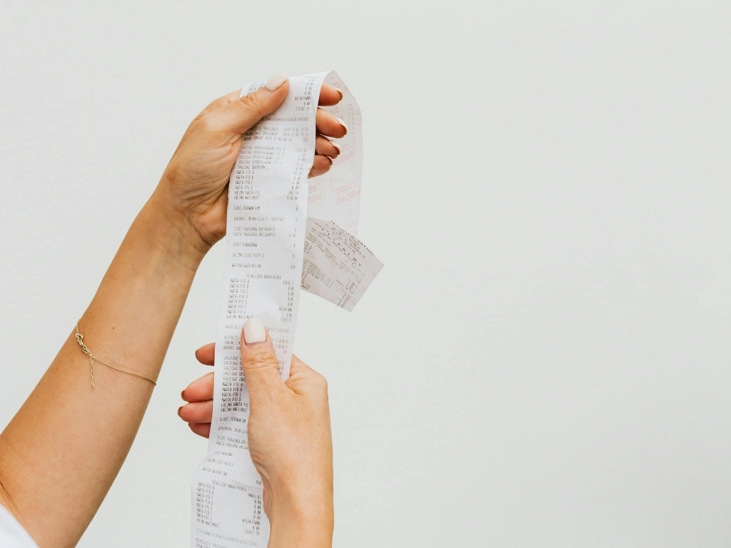 A woman holding a receipt