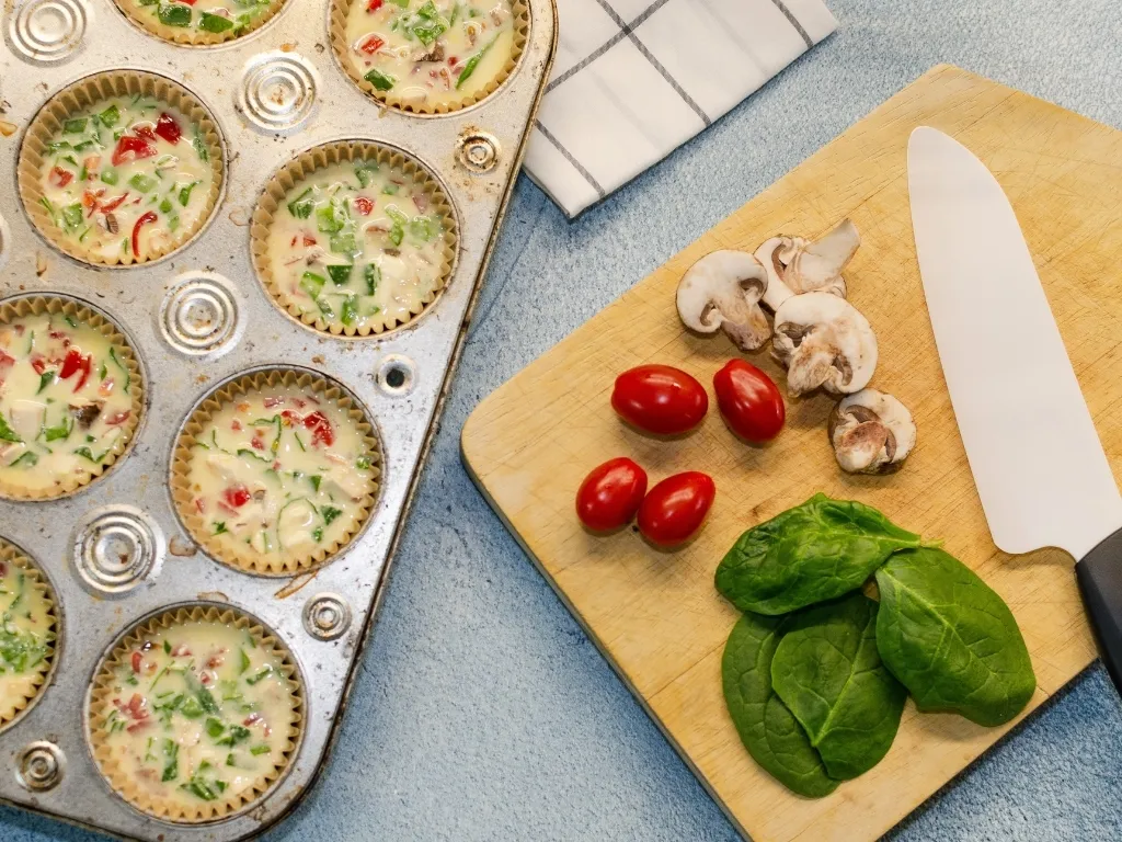 Breakfast meal prep with healthy vegetables and eggs, tomatoes, spinach, mushrooms
