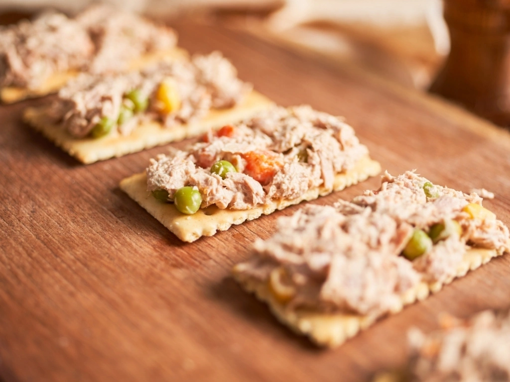 Tuna salad with whole-grain crackers and peas