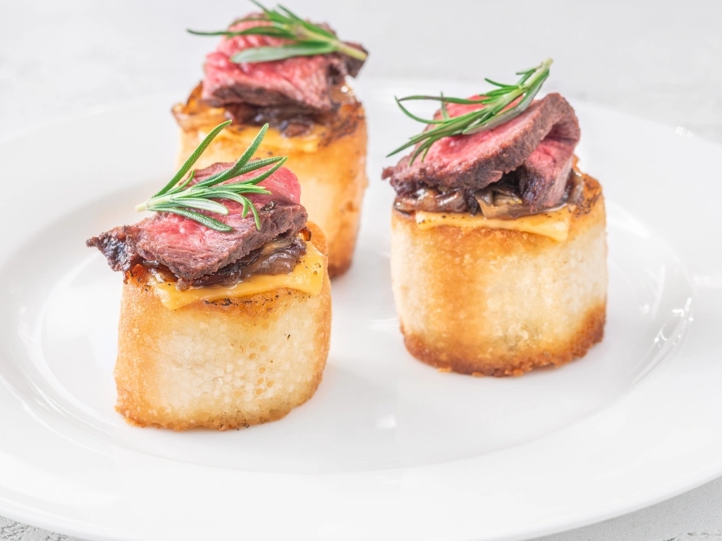 Three servings of roast beef crostini in a plate