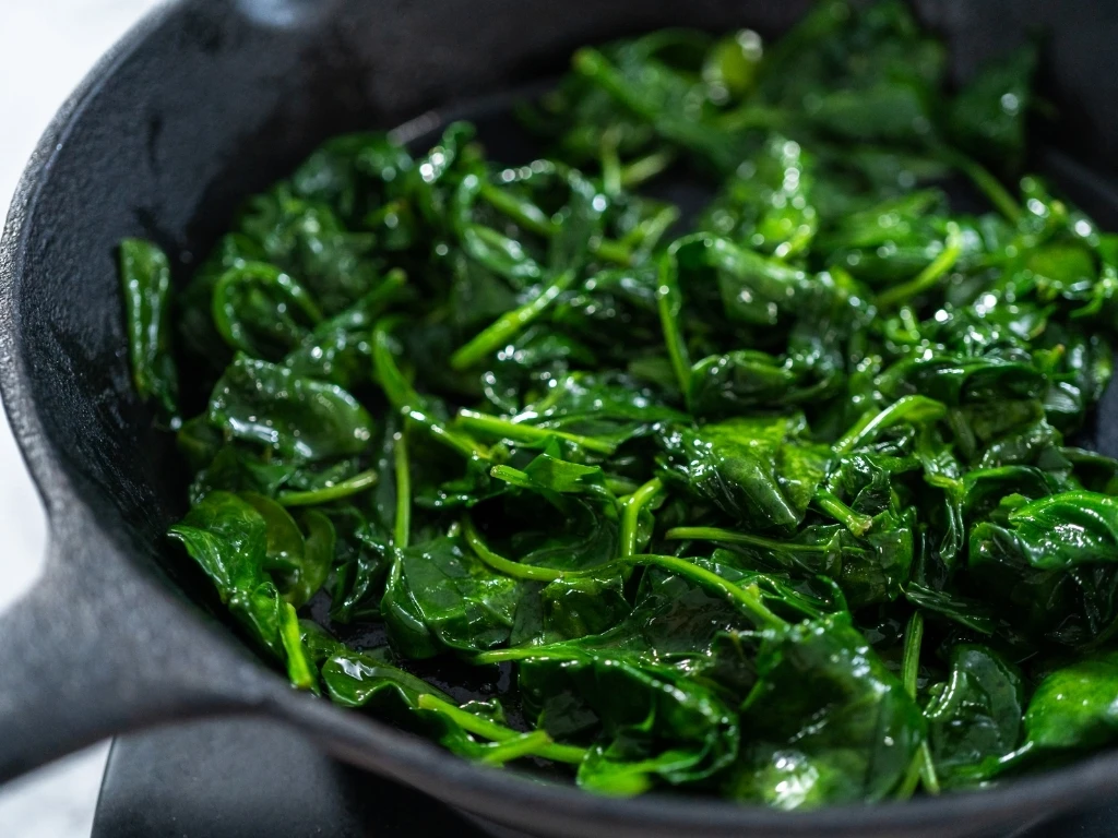 Sautéed spinach in a cast-iron skillet