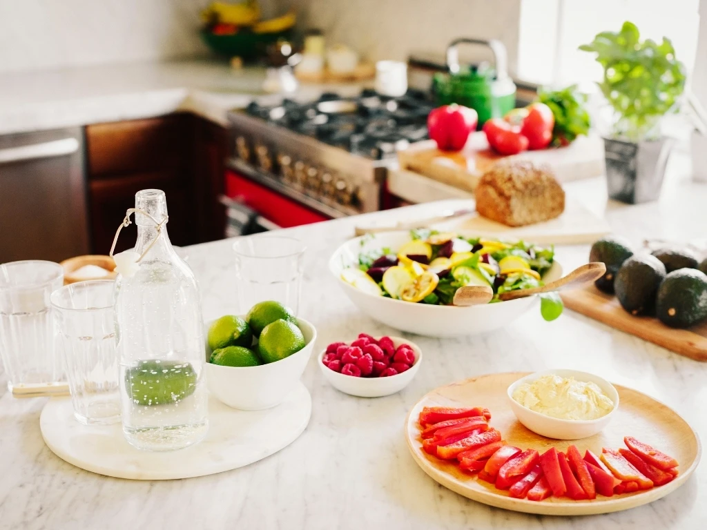 A choice of prepared fresh salads on a kitchen counter.