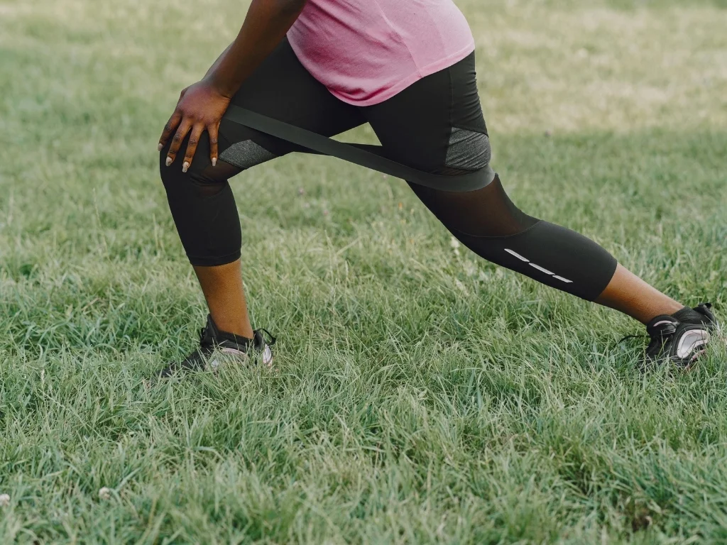 Woman working out in a grass field