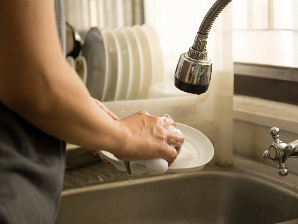 Person washing the dishes by hand