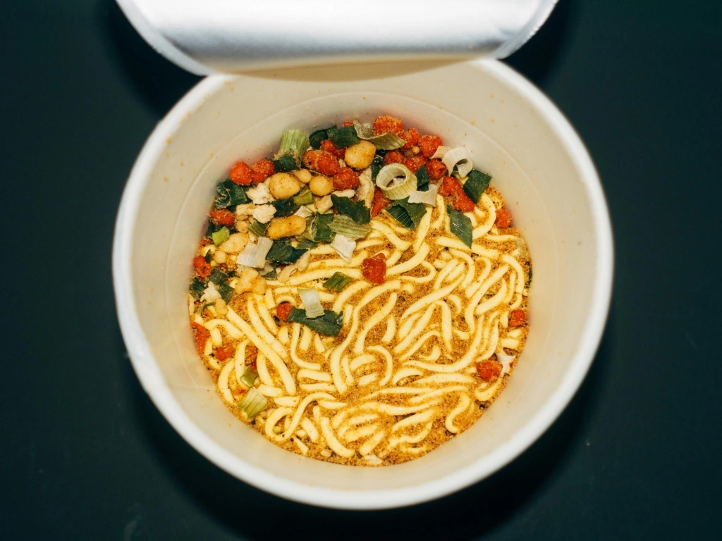Cup of instant noodles with dried vegetables and seasoning