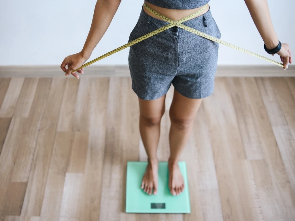 Slim Woman Measuring Waist For Diet Program