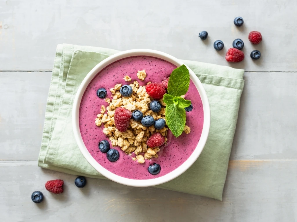 Smoothie Bowl with Granola and Berries on the Table.