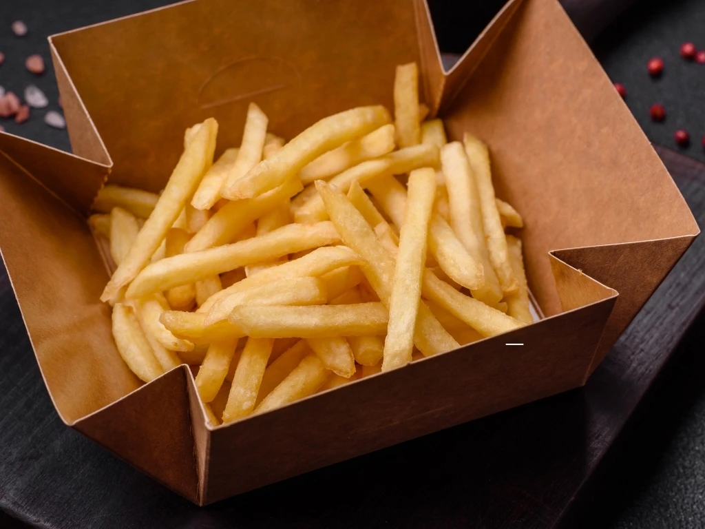 Fresh delicious crispy French fries with salt and spices