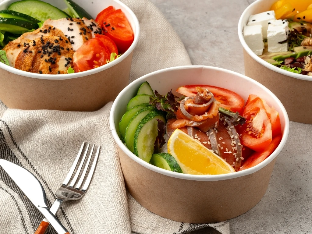Beautiful composition with poke bowls on gray background with napkin