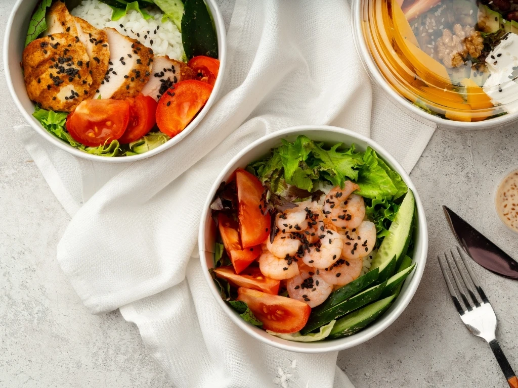 Beautiful composition with poke bowls on gray background with napkin