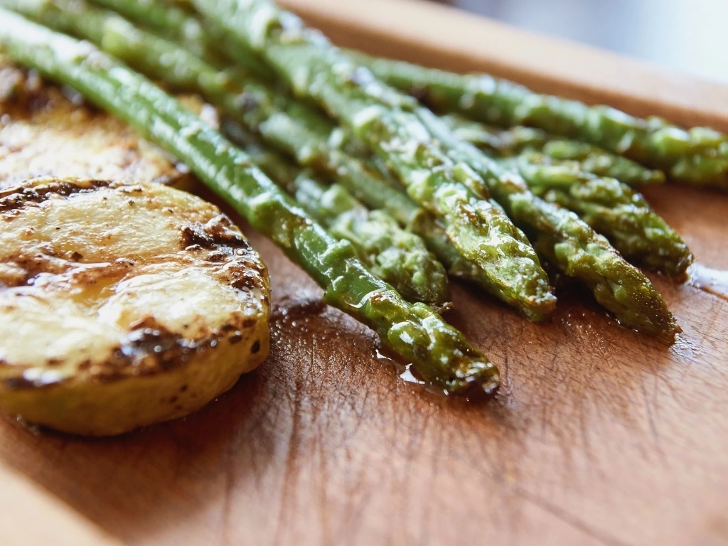 Green asparagus and squash on a wooden board