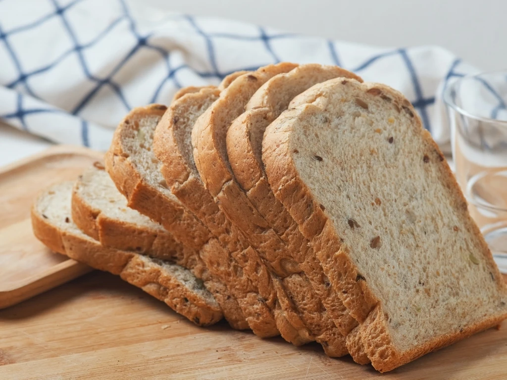 Sliced whole-wheat bread on a wooden board