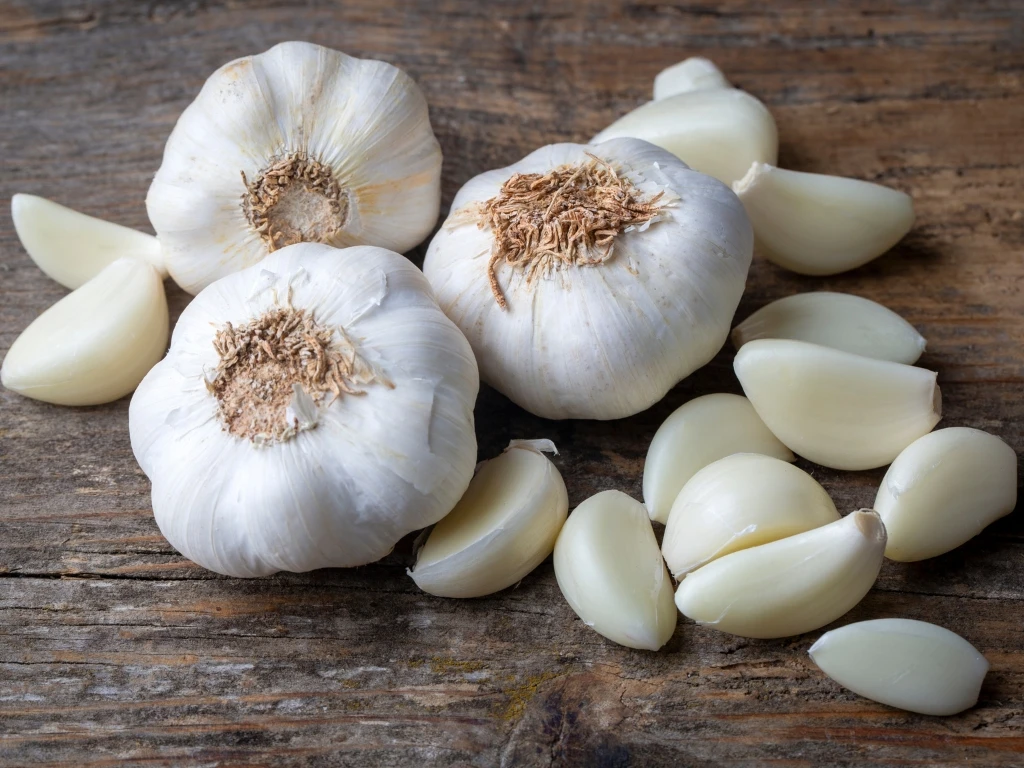 Garlic bulbs and cloves on a wooden table