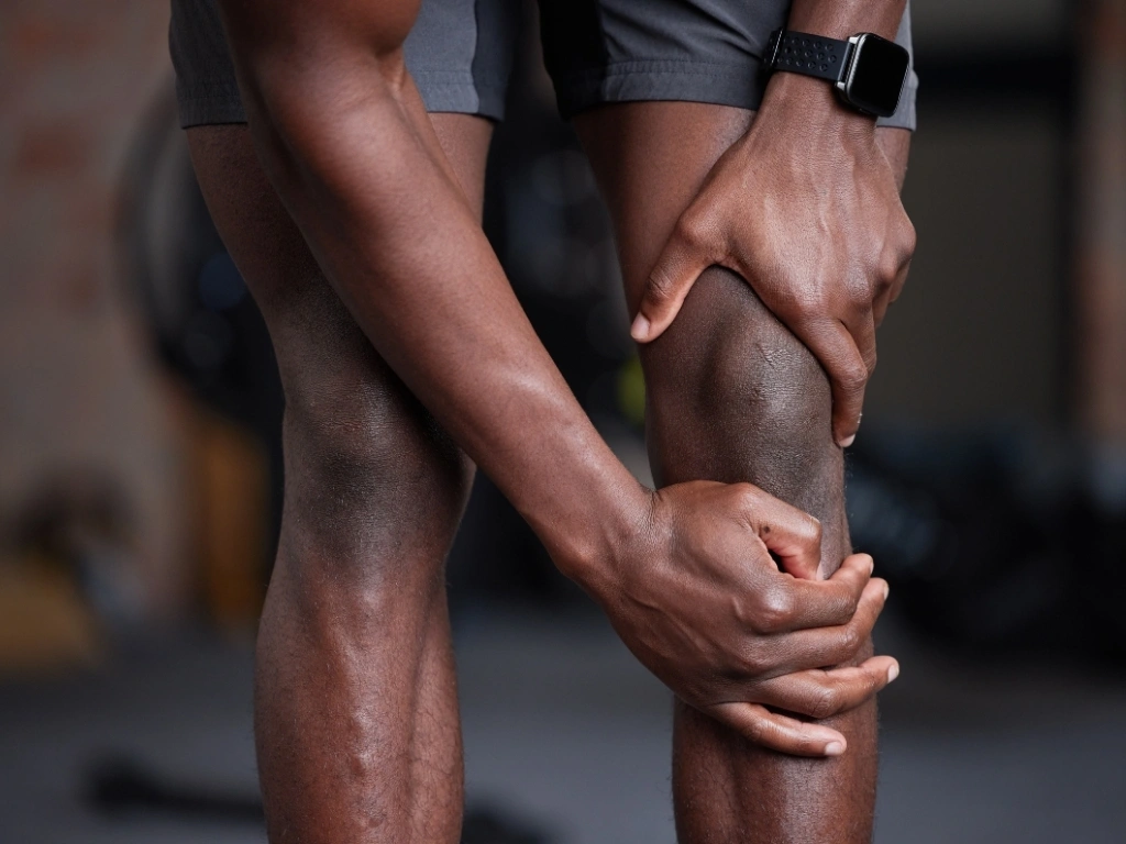Man holding one knee due to joint pain