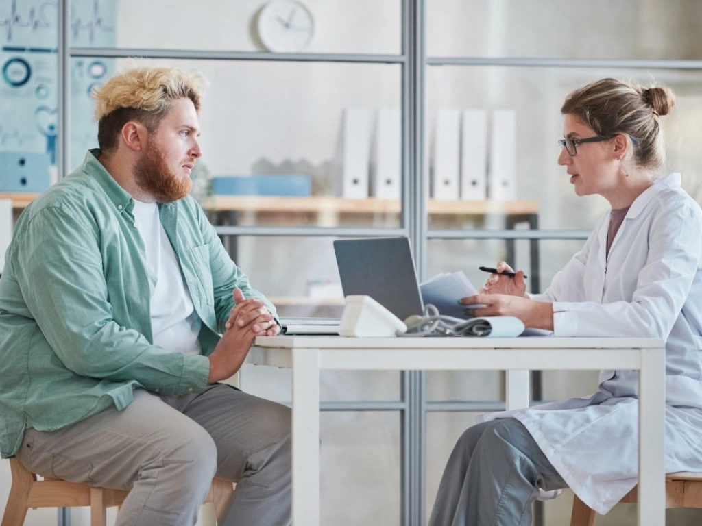 Man talking to the doctor at office