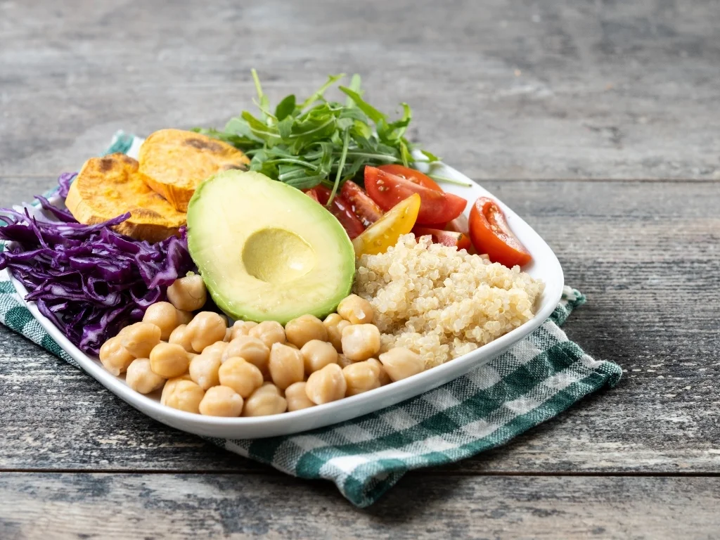 A balanced, plant-based meal with avocado, lettuce, tomato, and chickpeas