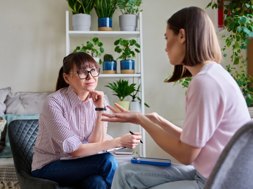 Therapist listening intently to a young woman