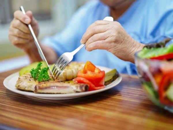 Elderly woman eating a healthy meal