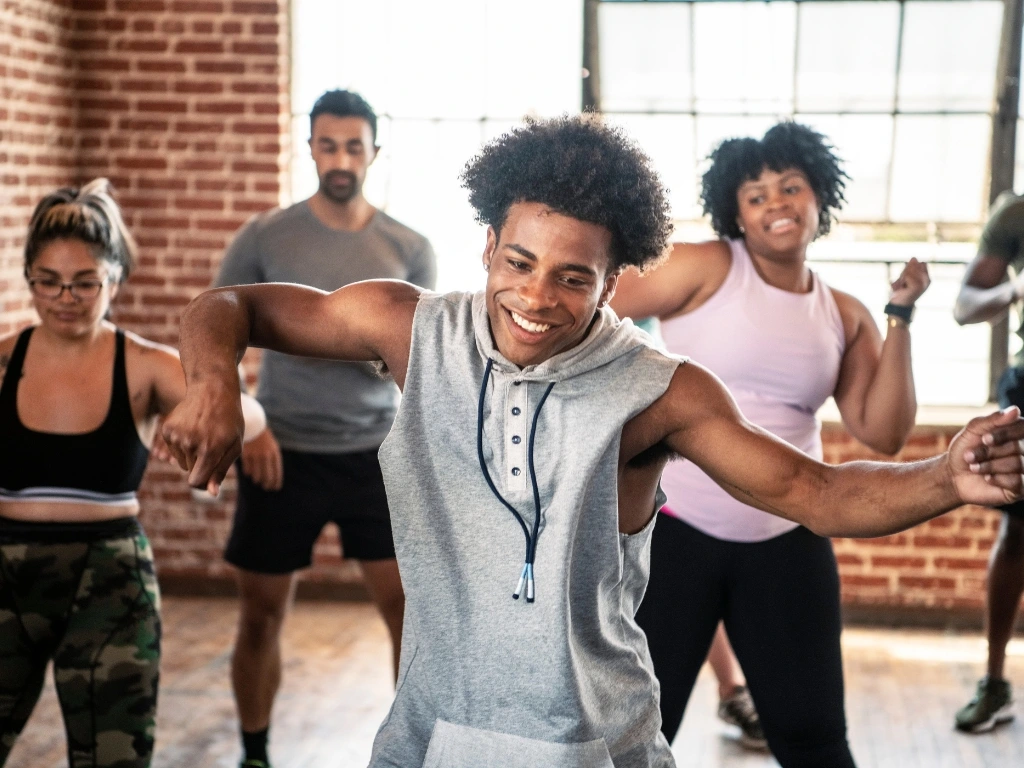 Group of adults taking an exercise class in a studio