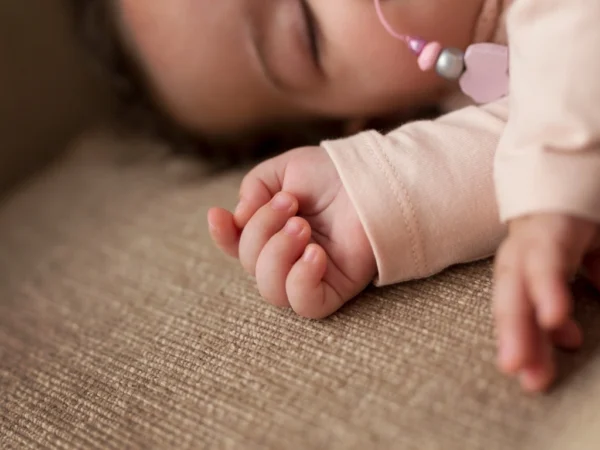 Sleeping infant with hands in focus